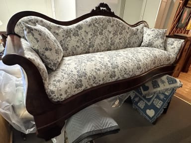 restored couch frame with dark stain and new upholstery