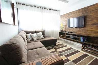 contemporary living room with couch and hanging entertainment center