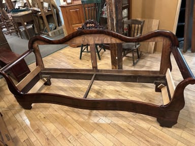 damaged couch frame with upholstery removed